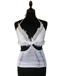 White crochet top and bottom set on a black mannequin against a white background